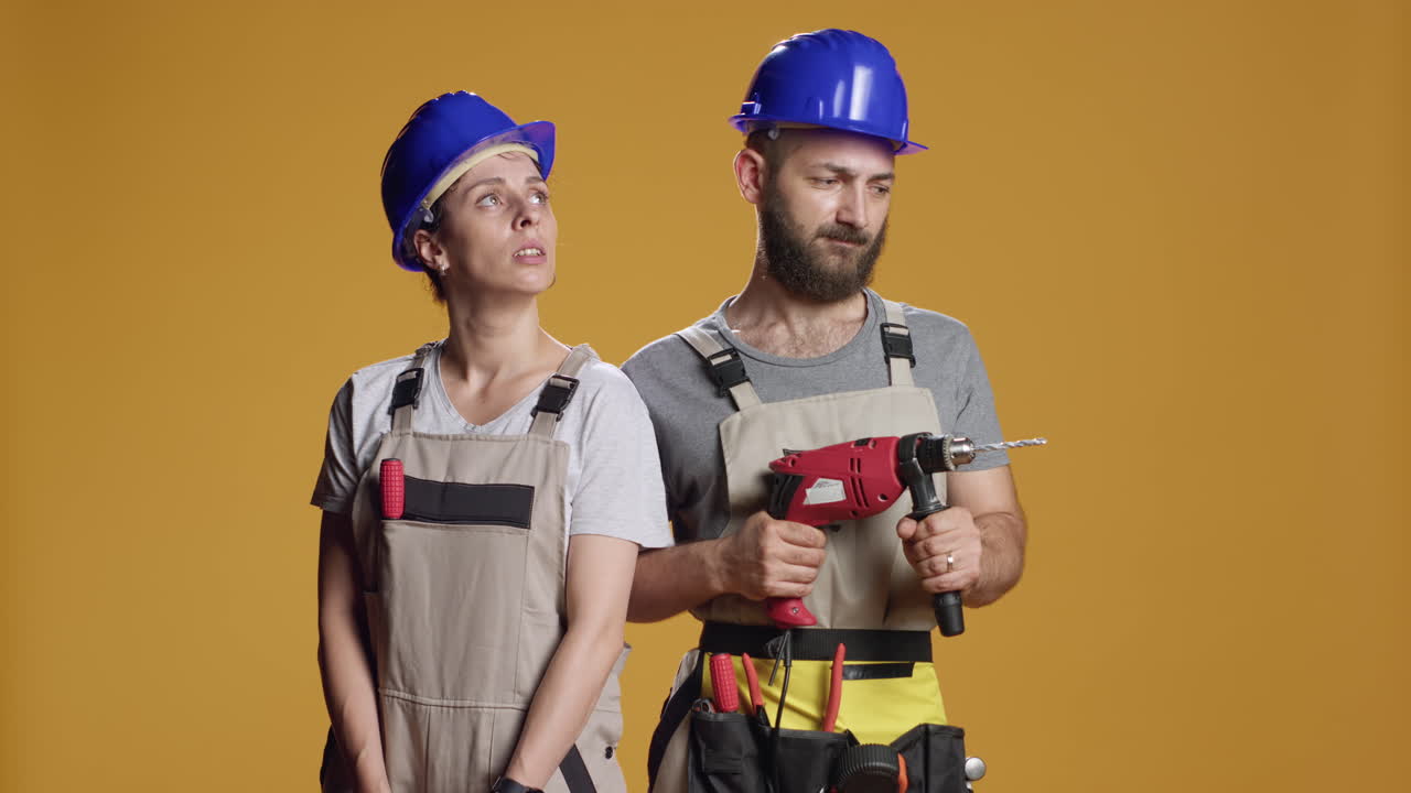 Team of contractors working with electric power drill machine