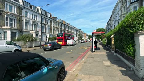 vehicles and pedestrians at a london bus stop