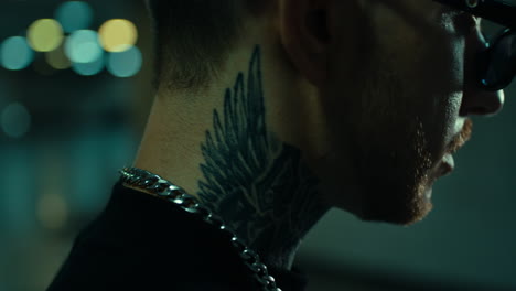 close-up of a man with a wing tattoo