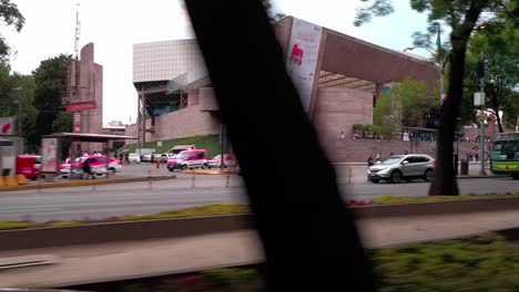 modern city scene with pink taxis near a contemporary building during the day