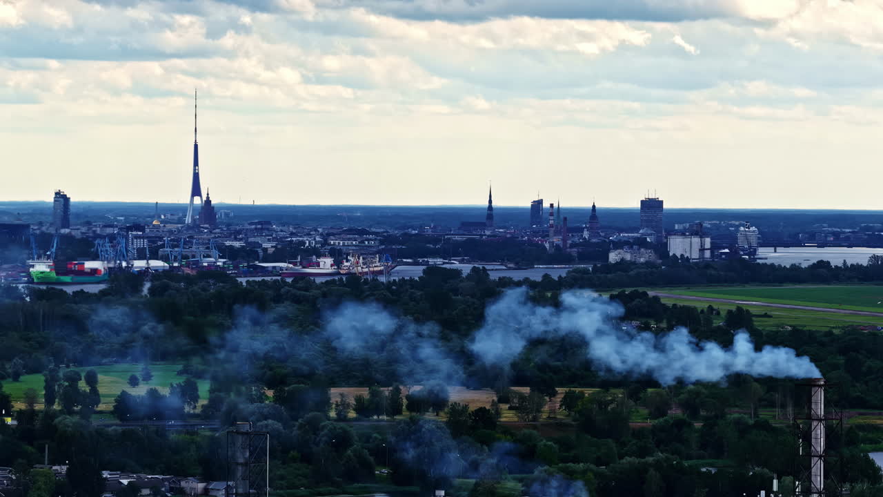 Riga Latvia city skyline industrial factory manufacturing business smoke pollution chimney, aerial