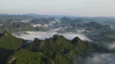 drone moves backward from misty mountain range