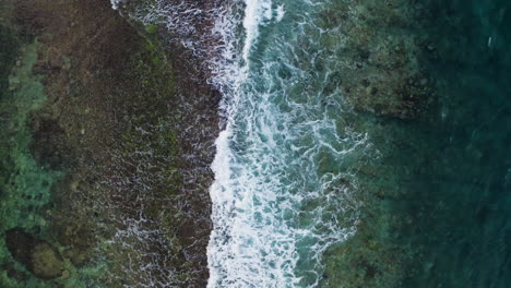 Waves-crushing-on-rock-top-view-perspective-from-drone