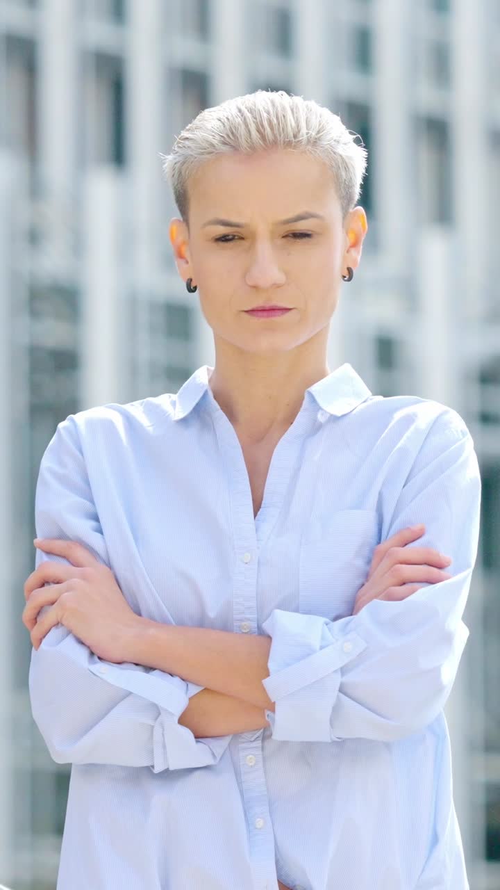 Confident woman with short hair and crossed arms