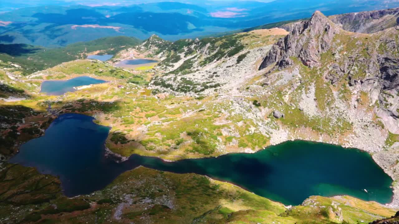 View of the Rila lakes on a summer day	with a cloud passing through