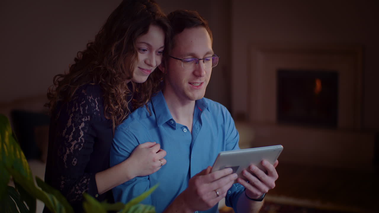 Couple enjoying tablet together at home
