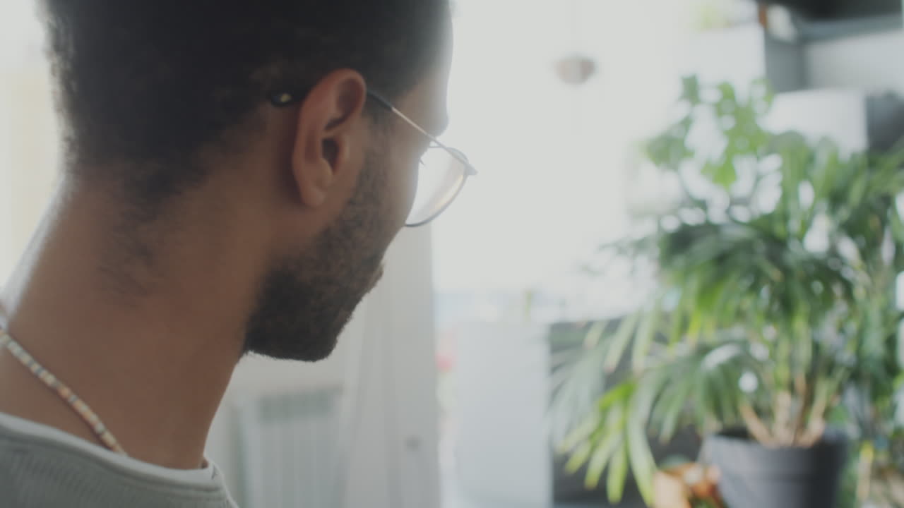 Broker Working with Laptop and Phone in Home Office