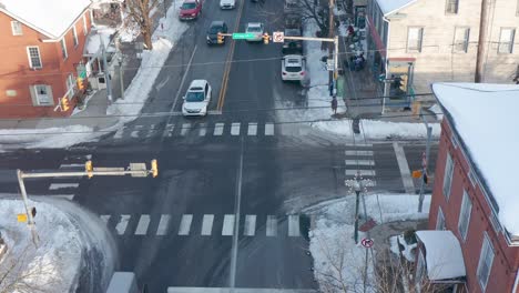 amish horse and buggy pass through busy town intersection in lancaster county, pa