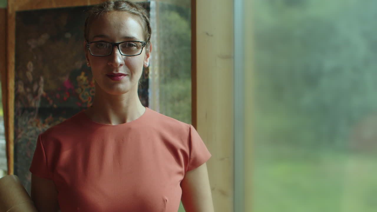 Young wife of architect, designer looks proudly and confidently into the camera