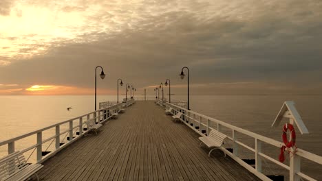 beautiful smooth walk of a wooden jetty towards the baltic sea and the sunrise at the horizon, gdynia, poland