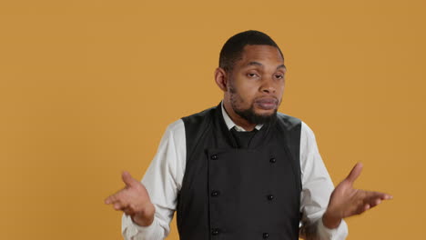 professional waiter showing clueless sign and being unsure