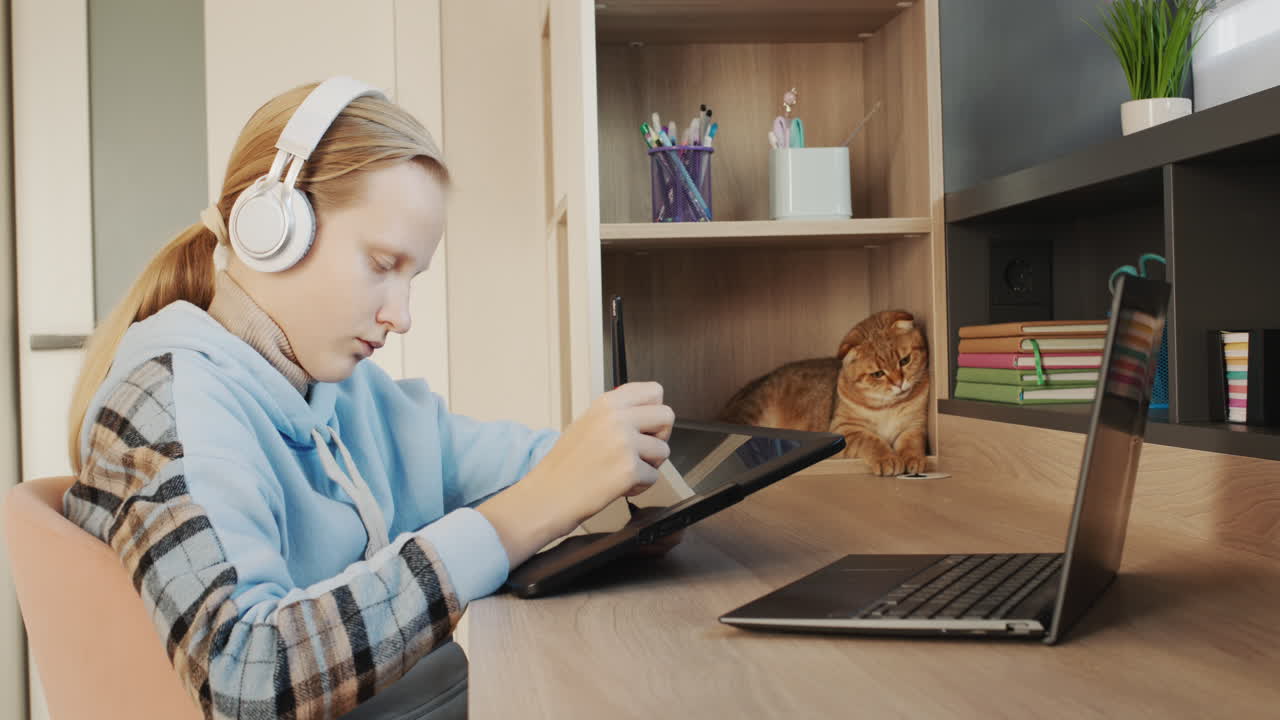 Child draws, uses a digital graphics tablet. Inspiration and new technologies.