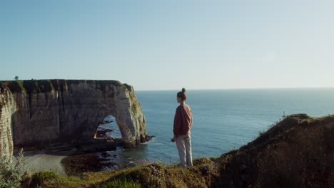 girl watching the ocean from cliffs