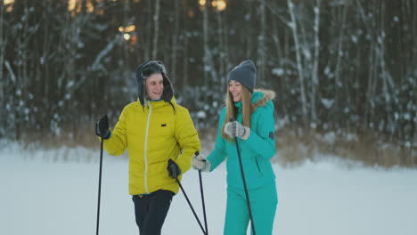 man and woman in love with ski equipment going to ski terrain