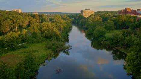 slowly drifting drone view over the huron river in ann arbor, michigan, in summer.
