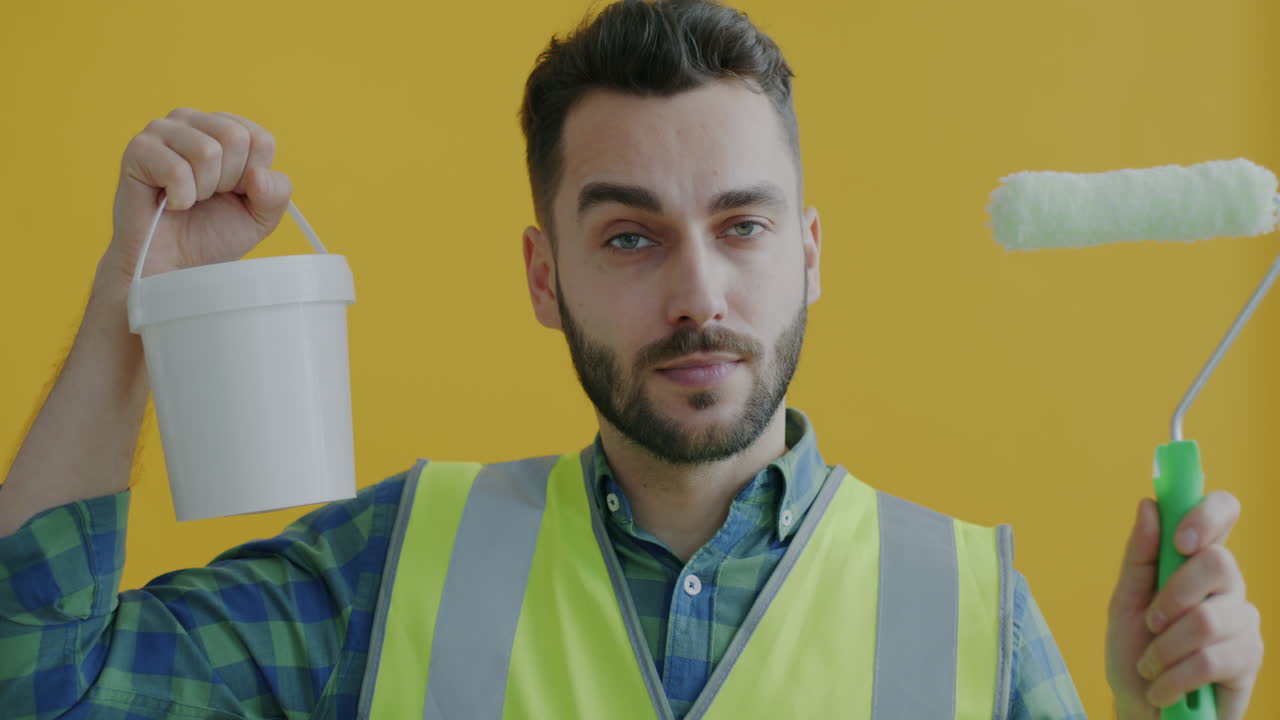 Man with paint roller and bucket