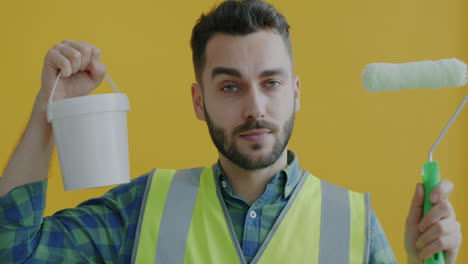 man with paint roller and bucket