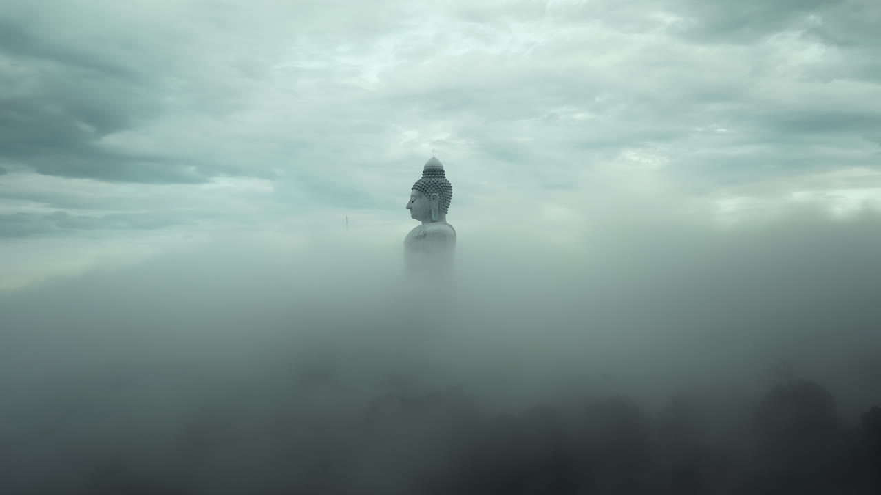 Giant Buddha Statue in Foggy Mountains