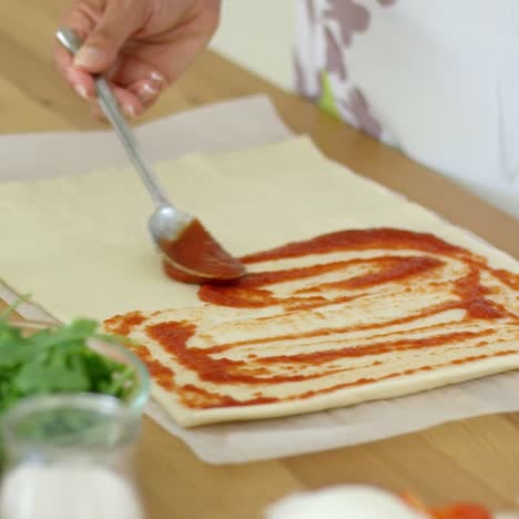 Woman-preparing-traditional-homemade-pizza