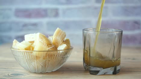 sugarcane juice being poured into a glass