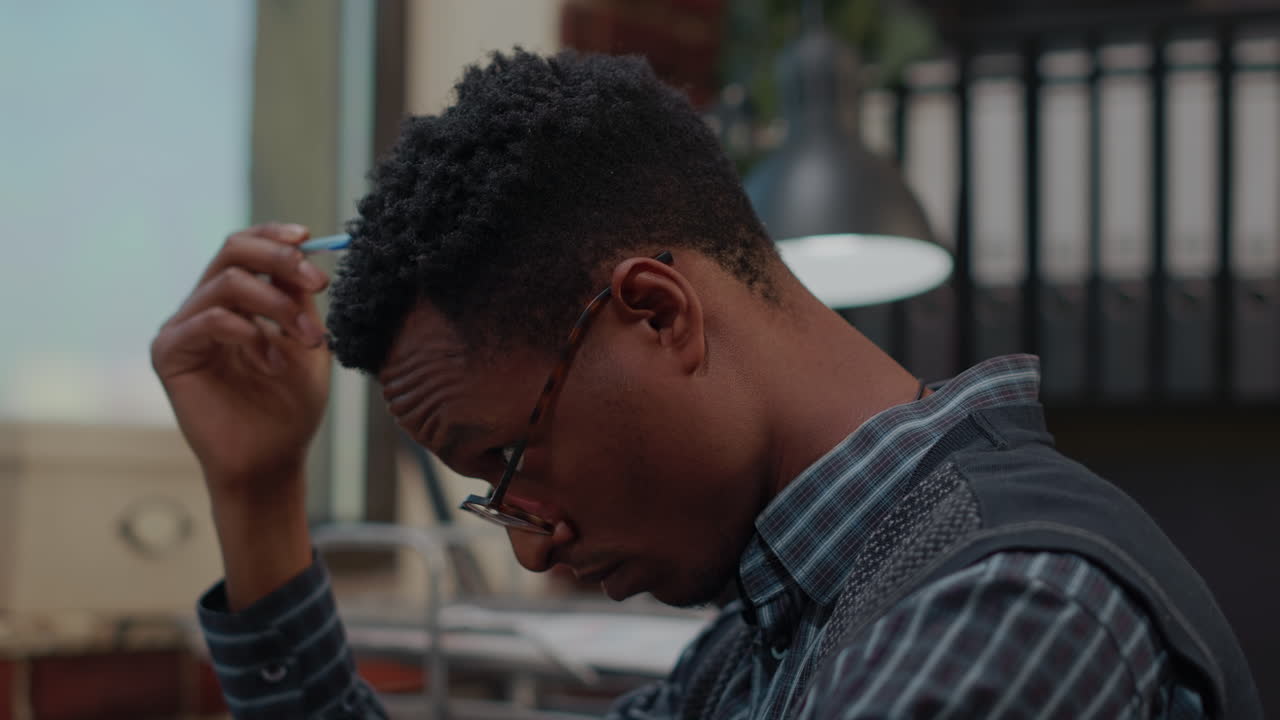 Pensive employee thinking about executive decision in office