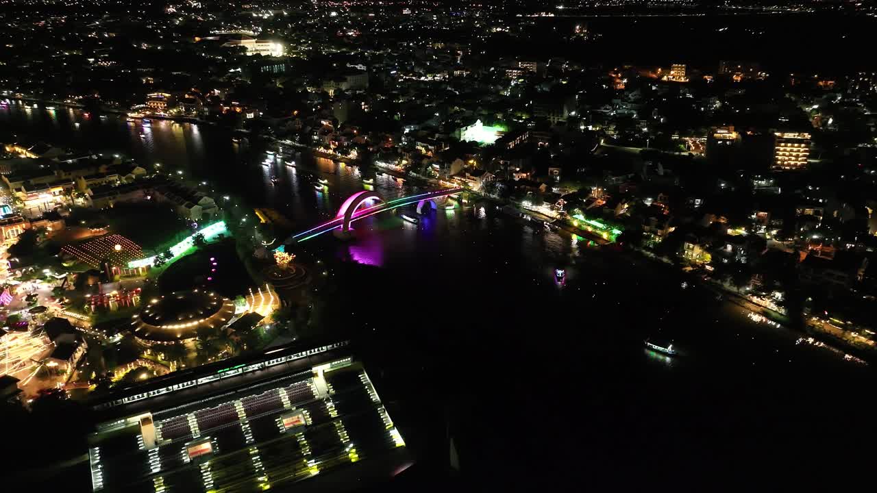 Vibrant cityscape of Hoi An, Vietnam, at night with colorful lights and river views