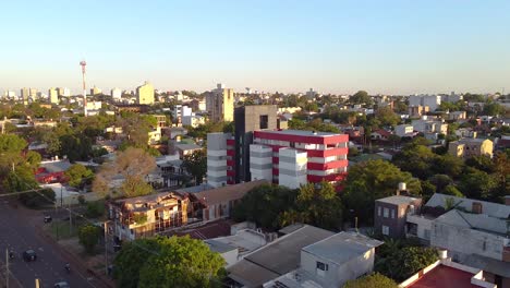 aerial drone view of posadas city in misiones argentina shows residential and office buildings with cars moving in the street