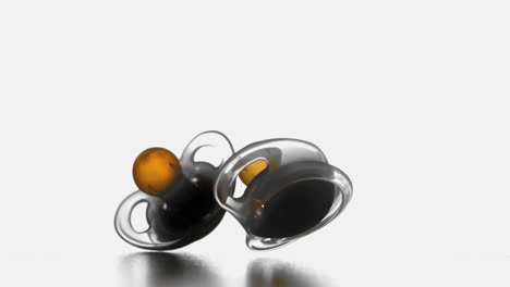 Two pacifiers falling