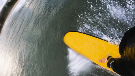 surfer surfing small wave on tropical island pov