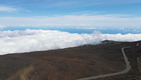 Heavenly-Road-Above-the-Clouds-on-Mountain-Summit-of-Haleakala-Volcano,-Maui---Aerial