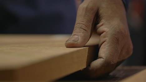 macro shot of a woodworker manufacturing wood product in a manufacturing factory