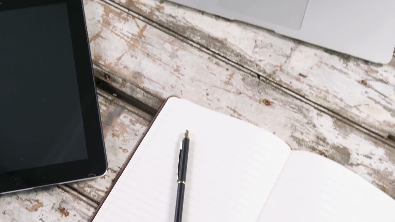 Digital tablet, laptop, smartphone and diary with pen