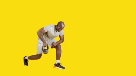 sportive african man doing exercises of row stoke with kettlebell