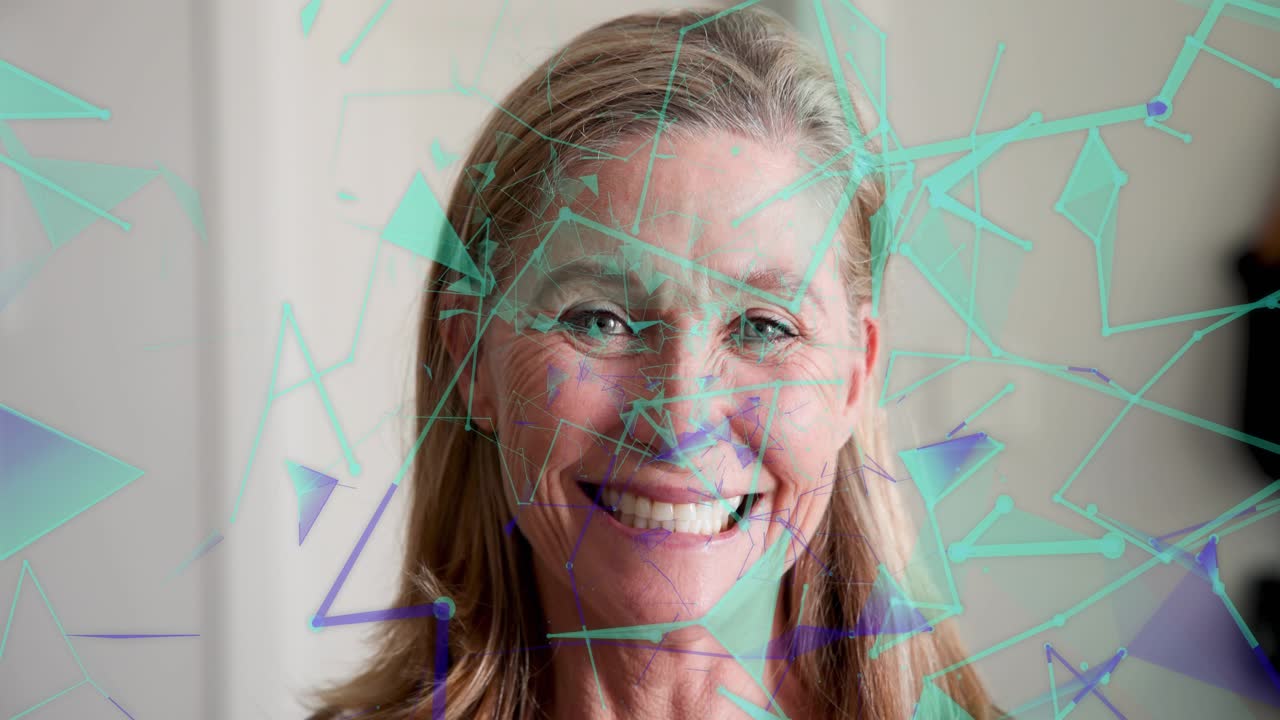 Woman facing camera smiling while teal shapes drifting over face causing laughter, showing design