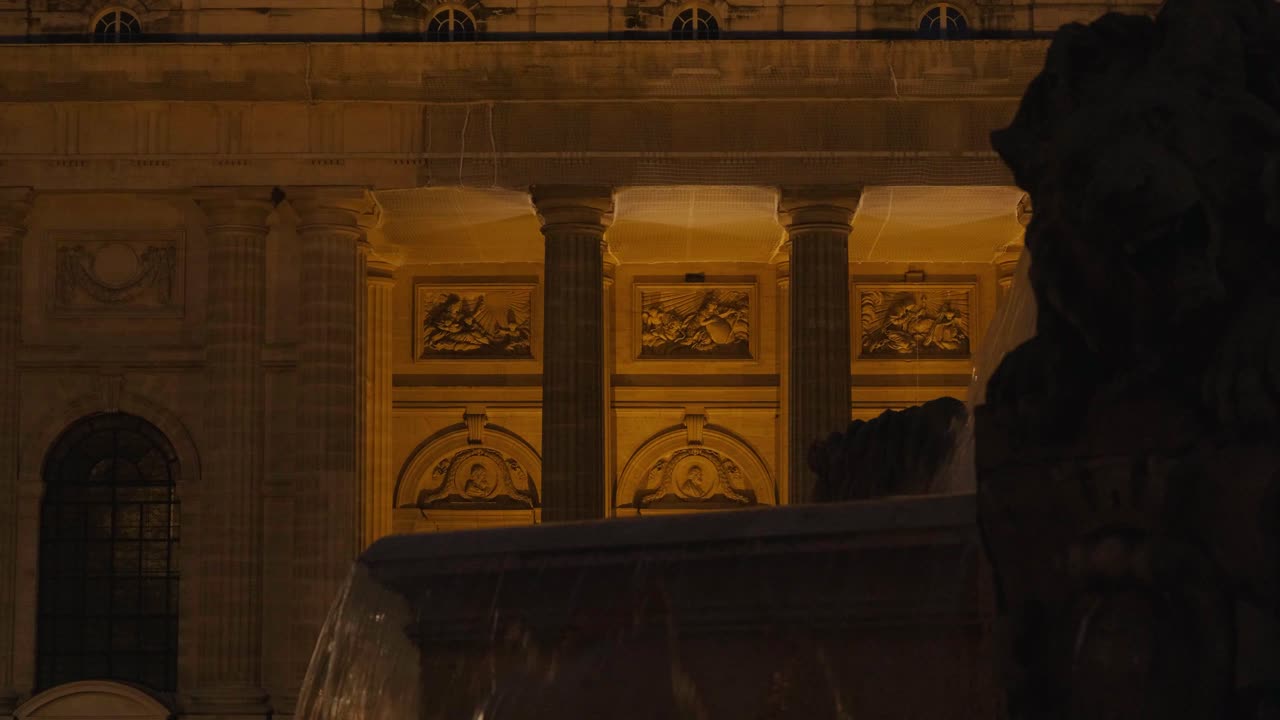 Historic Paris Fountain Illuminated Against the Church of Saint-Sulpice