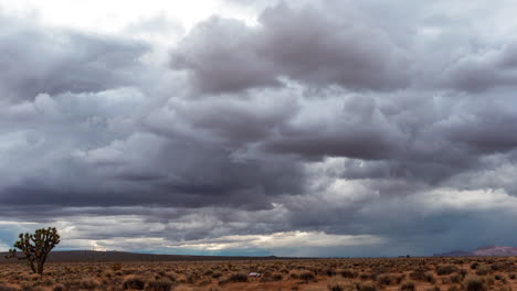 large, stormy cumulus rain clouds take shape over the mojave desert wilderness - time lapse