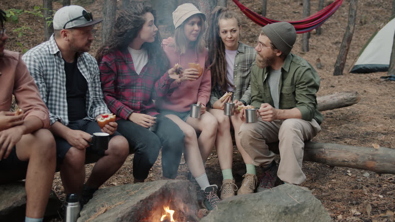 Friends enjoying campfire at nature