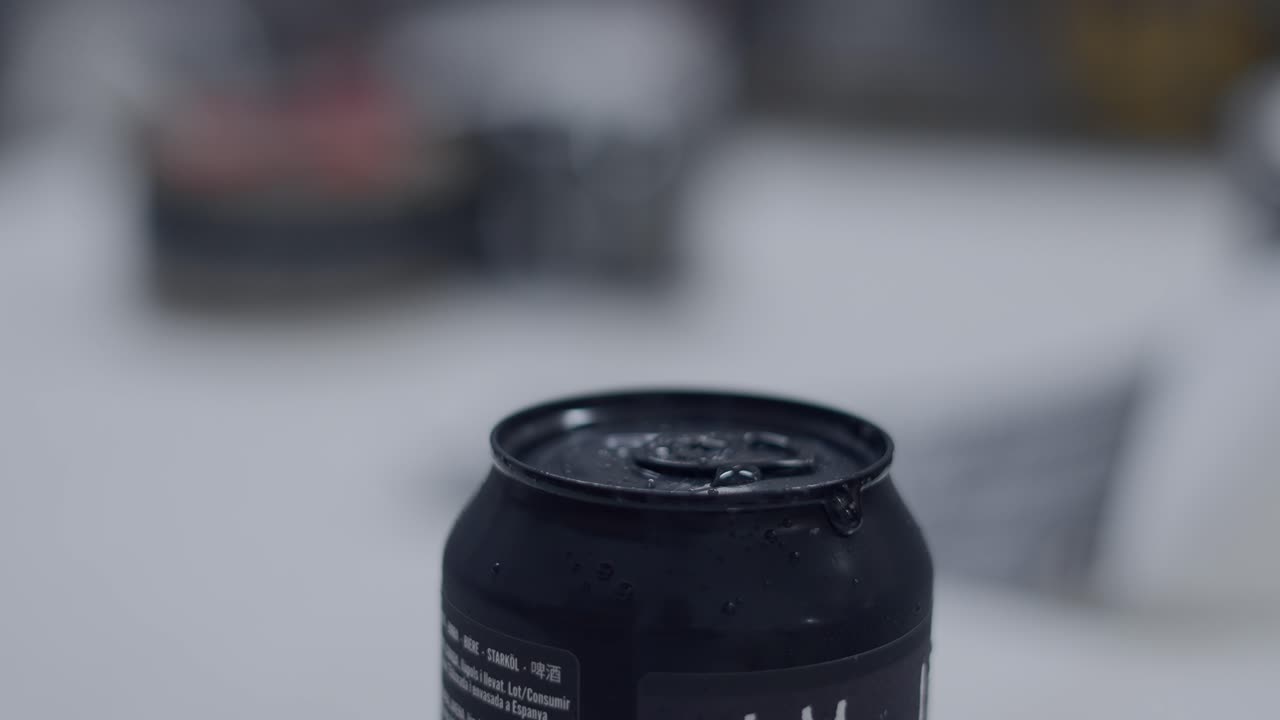 Close-up of a black can with water droplets