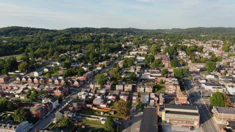 High-aerial-reverse-pullback-shot-to-reveal-residential-and-commercial-districts-in-Columbia,-Lancaster-County,-Pennsylvania-USA-during-summer-evening-magic-hour