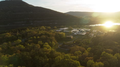 aerial footage flying away from moccasin bend during the sunset in chattanooga, tn with the sun reflecting off of the tennessee river