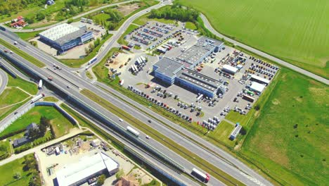 aerial view of warehouse storages or industrial factory or logistics center from above. top view of industrial buildings and trucks