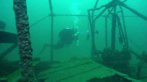 scuba diver explores water check valve on goldrush paddlwheel aj goddard