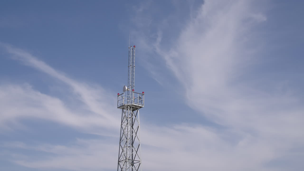 Telecommunication Tower Against a Cloudy Sky