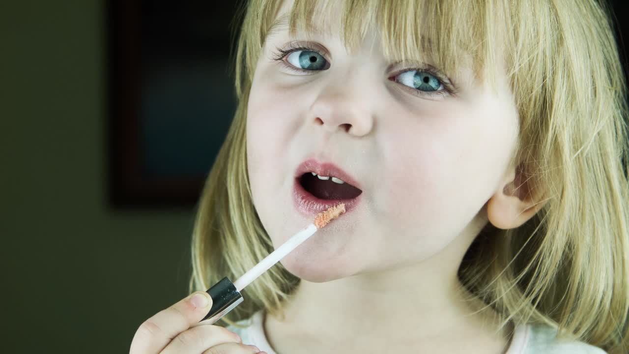 Little Girl Applying Lipstick