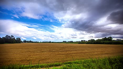 storm clouds building as weather moves over harvested farmland