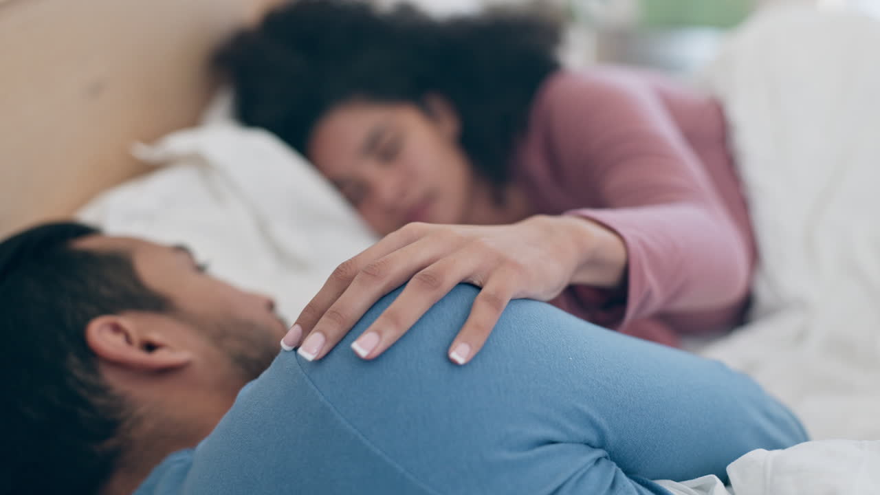 Bed, bond and hands of couple with love