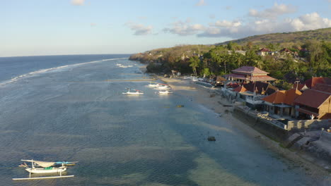 Drone-capture-amazing-Traditional-Hindu-Balinese-Fisherman-Sailing-Boat-on-windy-summer-day-with-golden-sunshine-and-Big-Indian-Ocean-waves-crushing-on-shore