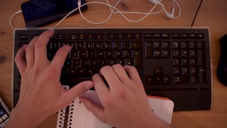 young man is writting a text on his computer using a keyboard-3