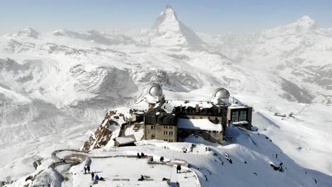 aerial flyover away from gornergrat with a view of the matterhorn during winter