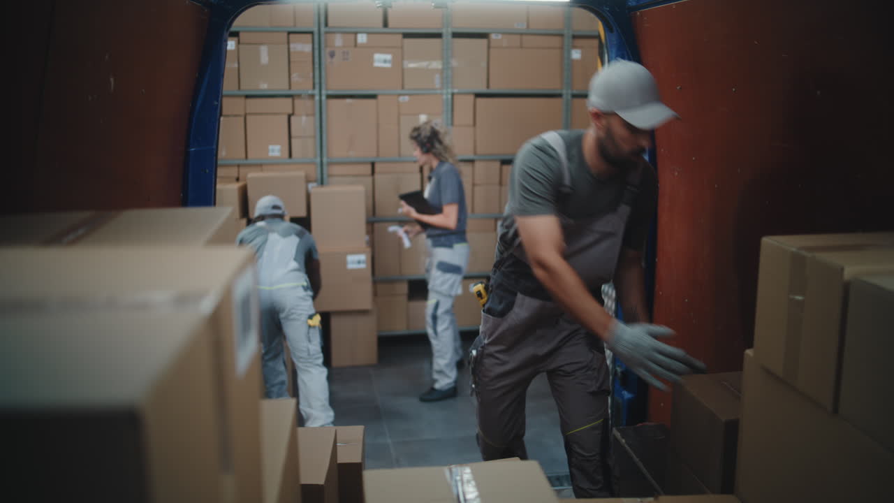 Warehouse and Delivery Team Efficiently Loading Boxes into a Van